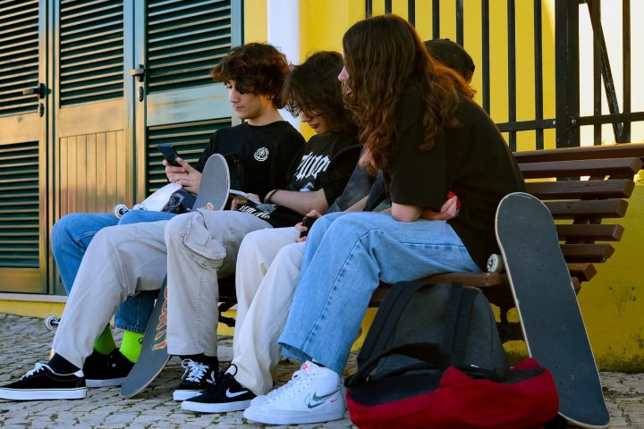 Εικόνα που απεικονίζει παιδιά να χρησιμοποιούν κινητά τηλέφωνα.